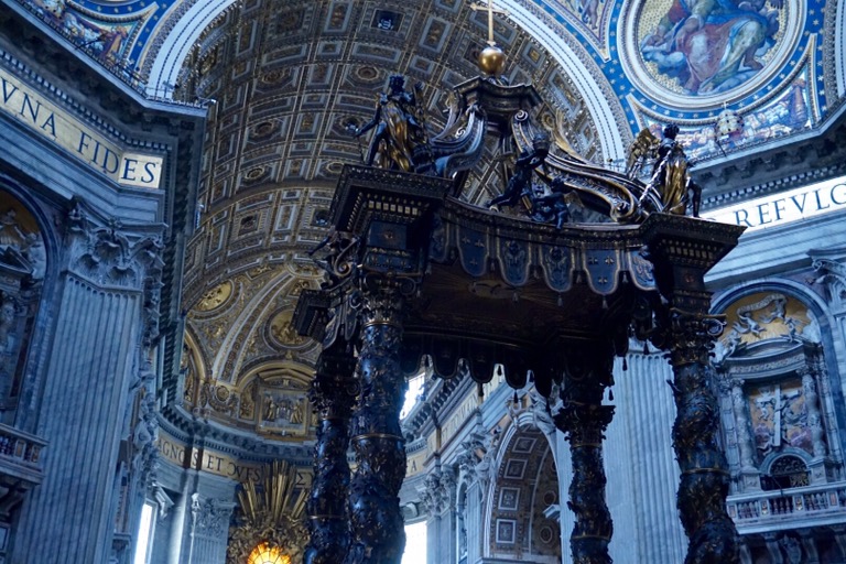 Bernini's bronze baldachin under the dome of St Peter's, its twisted columns rising above the altar