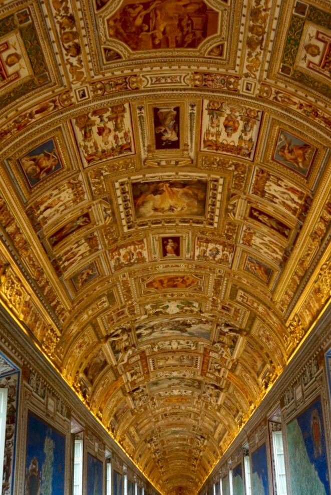 The Gallery of Maps, its gilded barrel vault running away above a crowd of visitors
