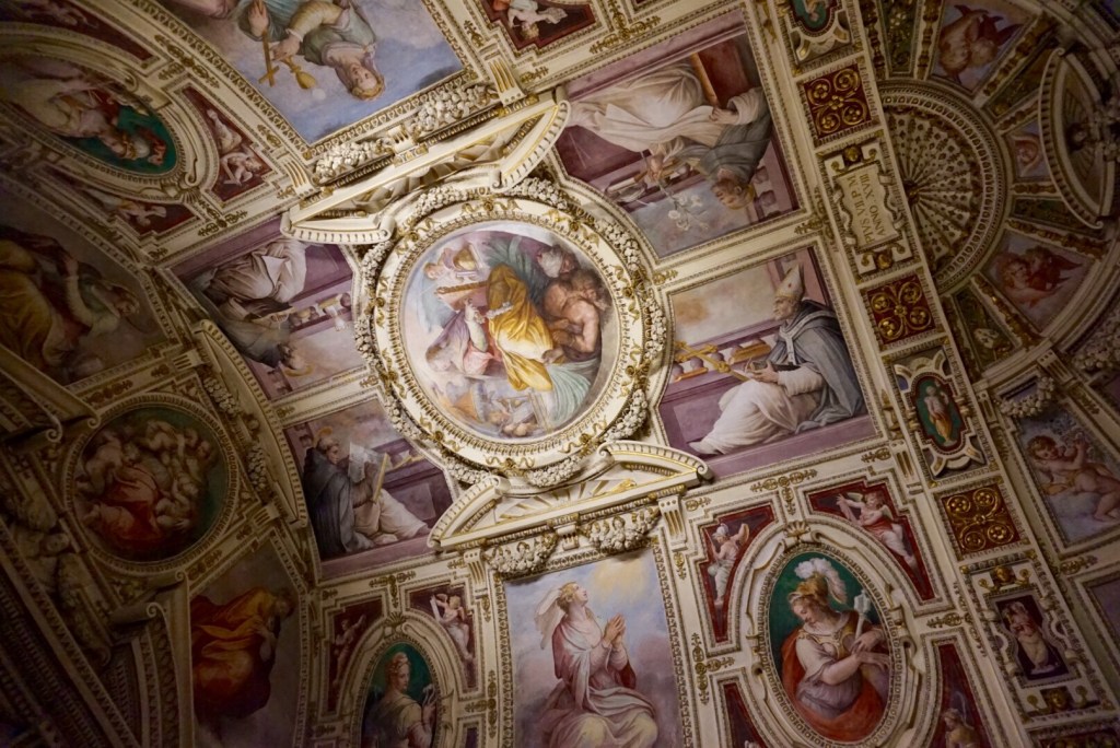 A gilded and frescoed vaulted ceiling in the Vatican Museums