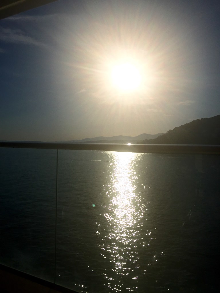 The sun going down over the water, seen from the ship