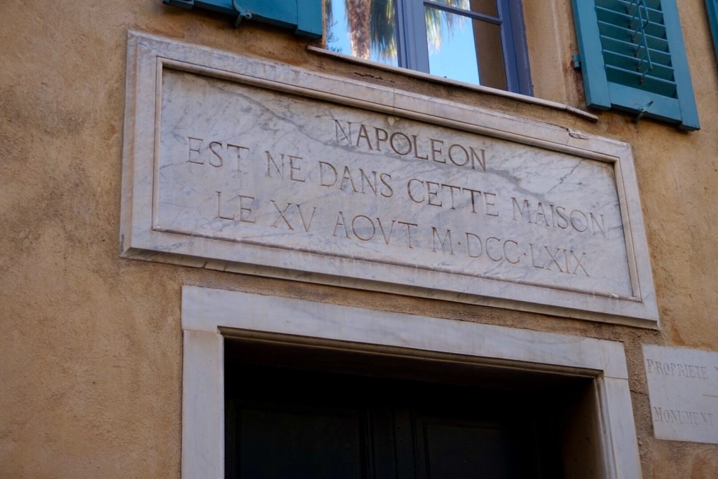 A marble plaque above a doorway recording that Napoleon was born in this house on 15 August 1769