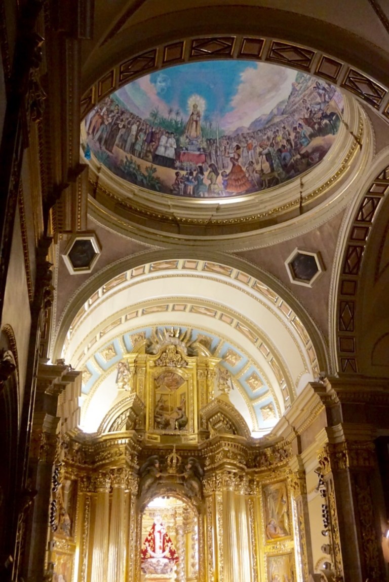 The gilded baroque altarpiece inside the shrine, below a painted dome
