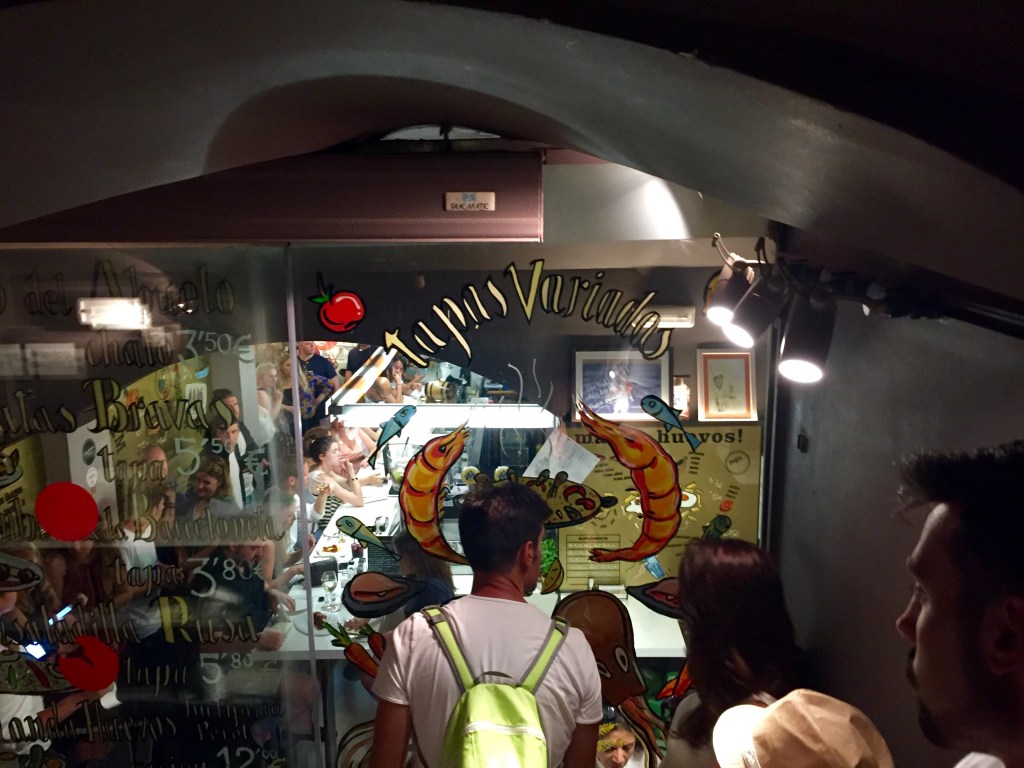 A vaulted room at night, a brightly lit window at the far end
