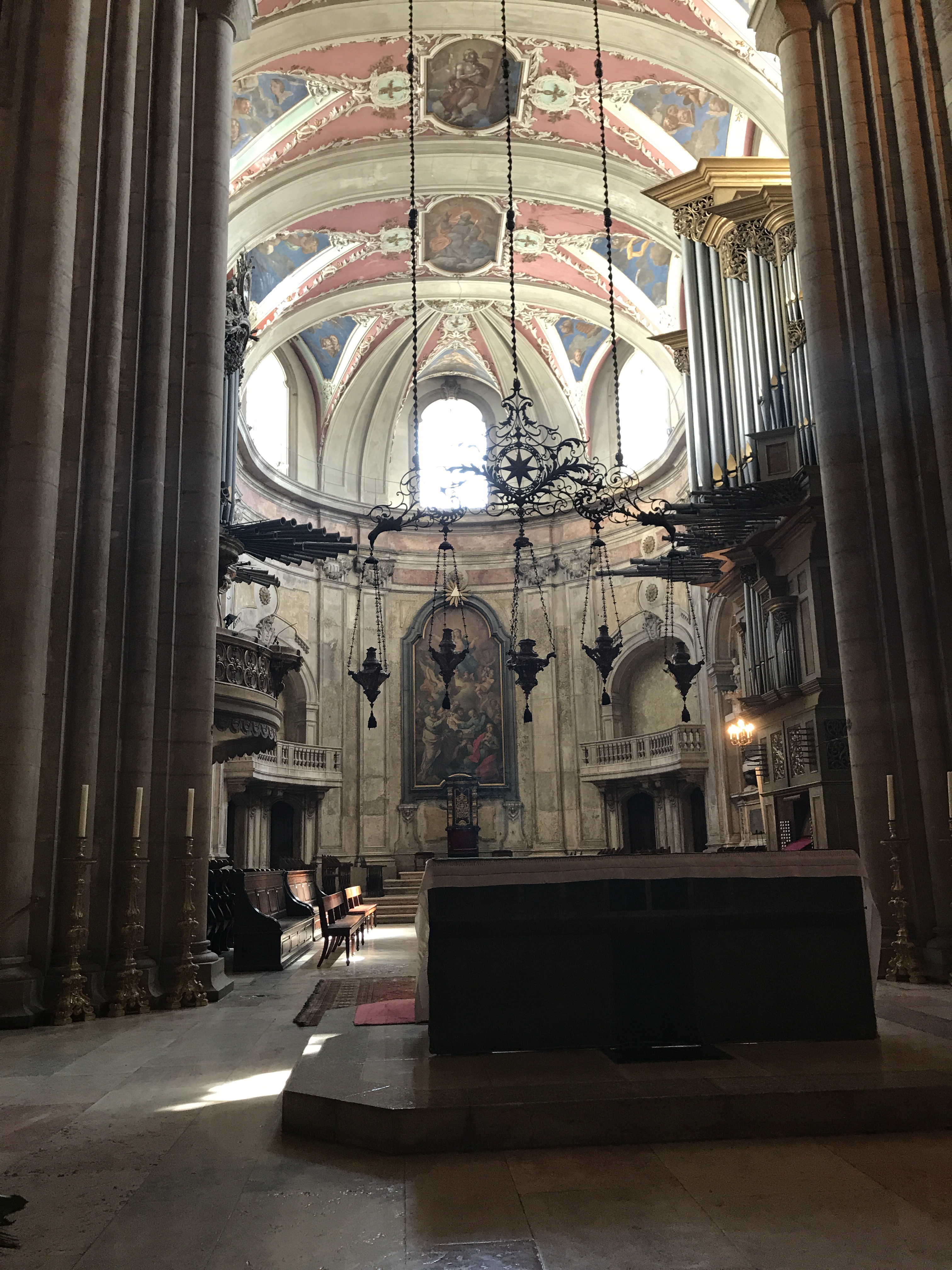 The interior of Lisbon Cathedral, the altar lit at the end of the nave