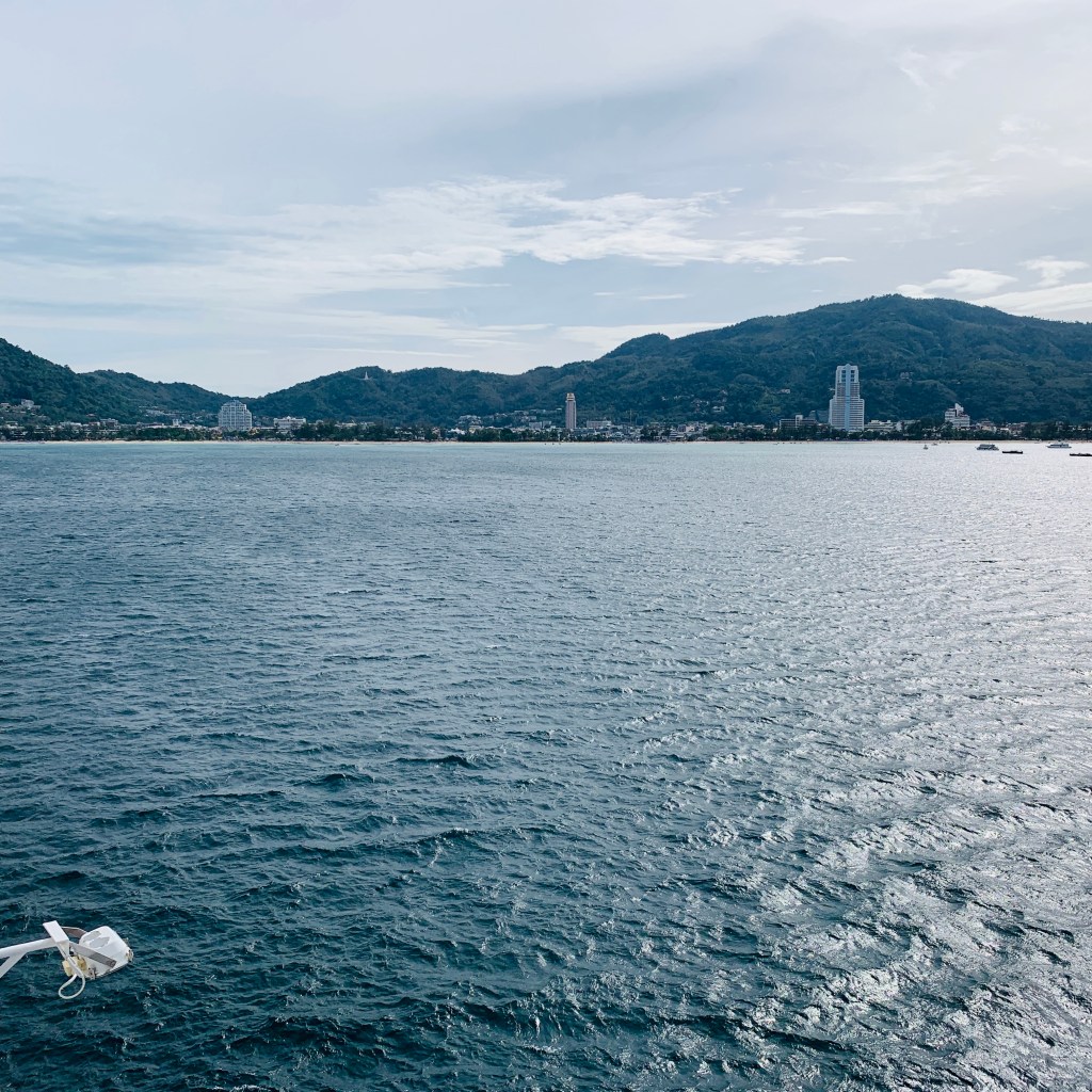 Grey water and a low headland ahead as the ship comes in towards Patong