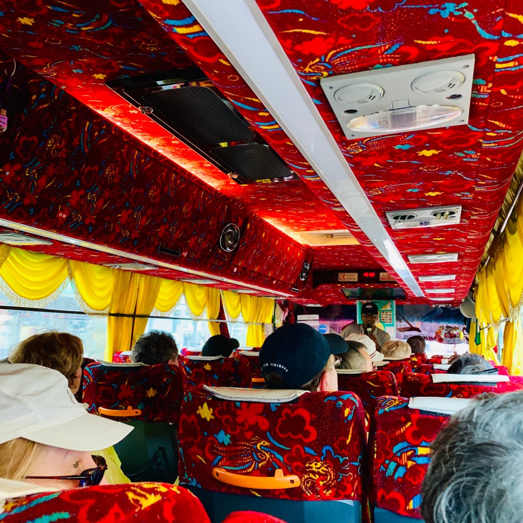 Inside the tour bus, red and orange from floor to ceiling