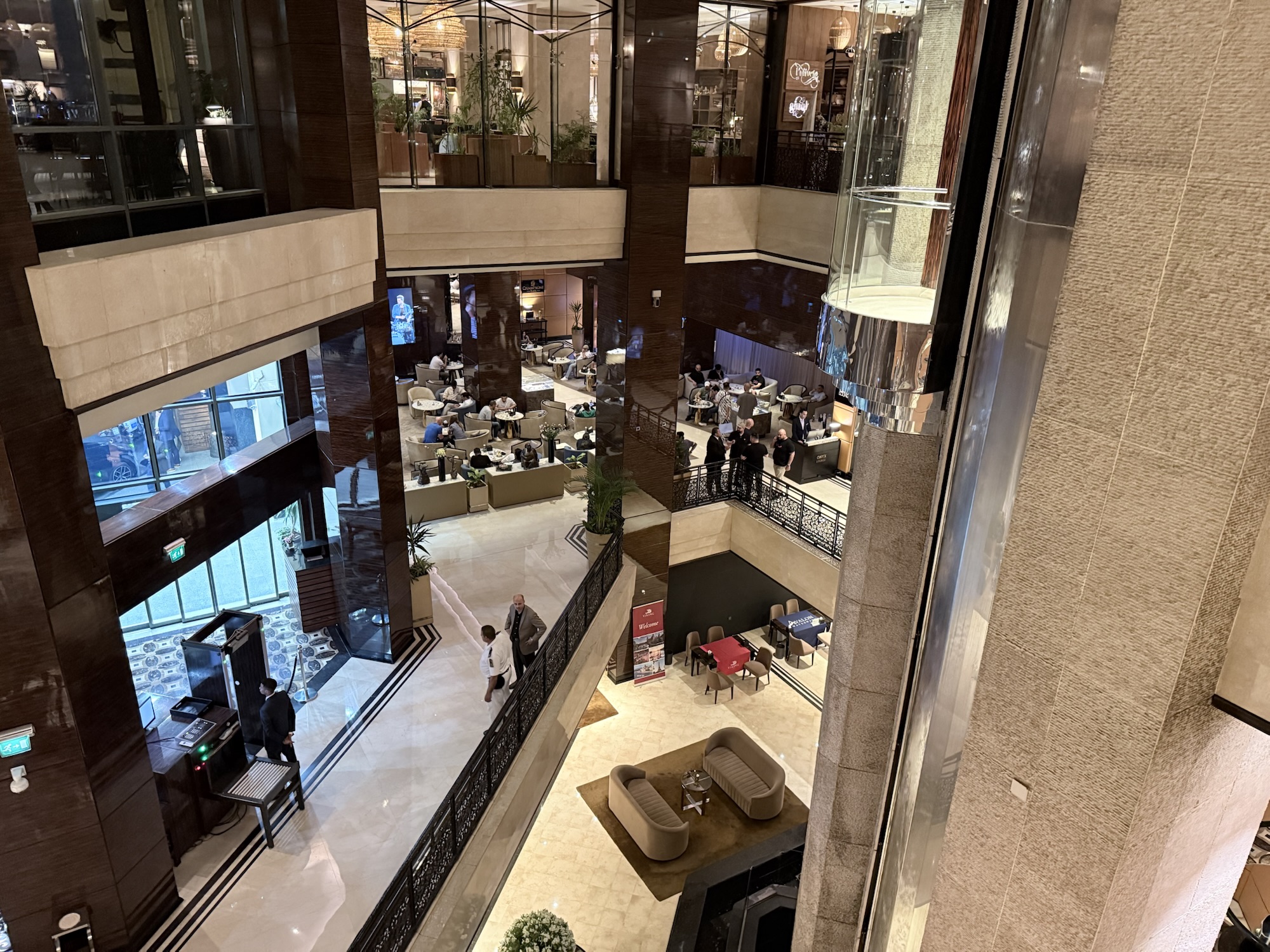 Looking down into the atrium of the Fairmont Nile City in Cairo, the bar and lounge seating below
