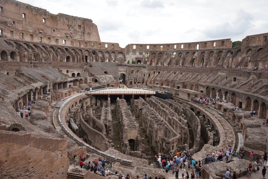 The exposed brick chambers of the Colosseum hypogeum with the reconstructed section of arena floor beyond