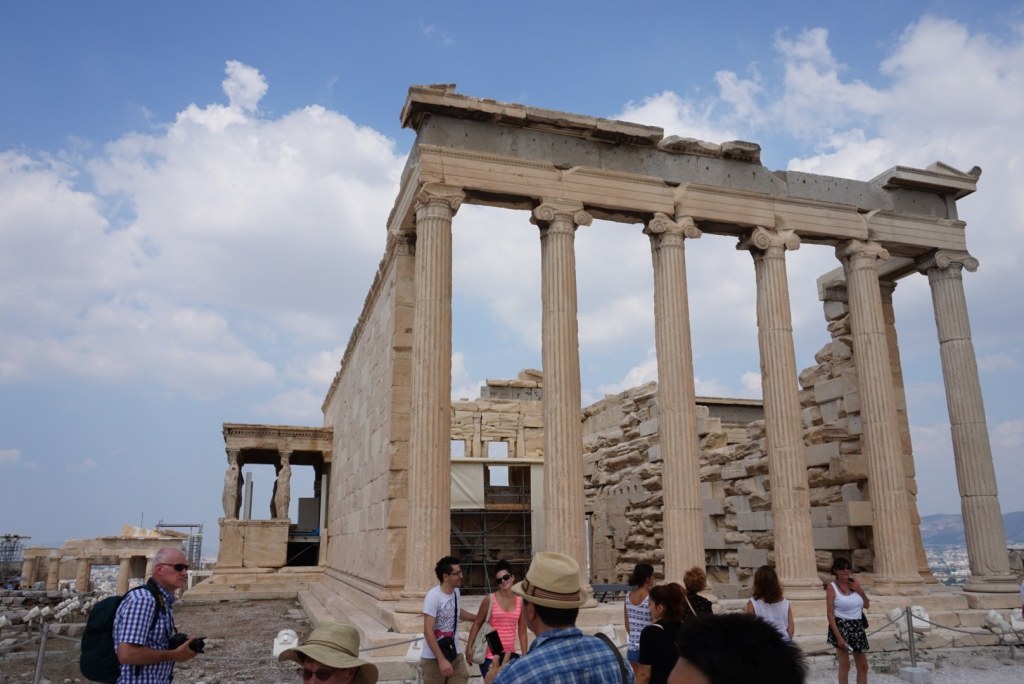 The Erechtheion seen from the west, its tall Ionic colonnade and the caryatid porch at the left