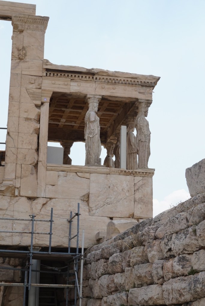 The Porch of the Caryatids, five draped figures carrying the roof above the ancient wall