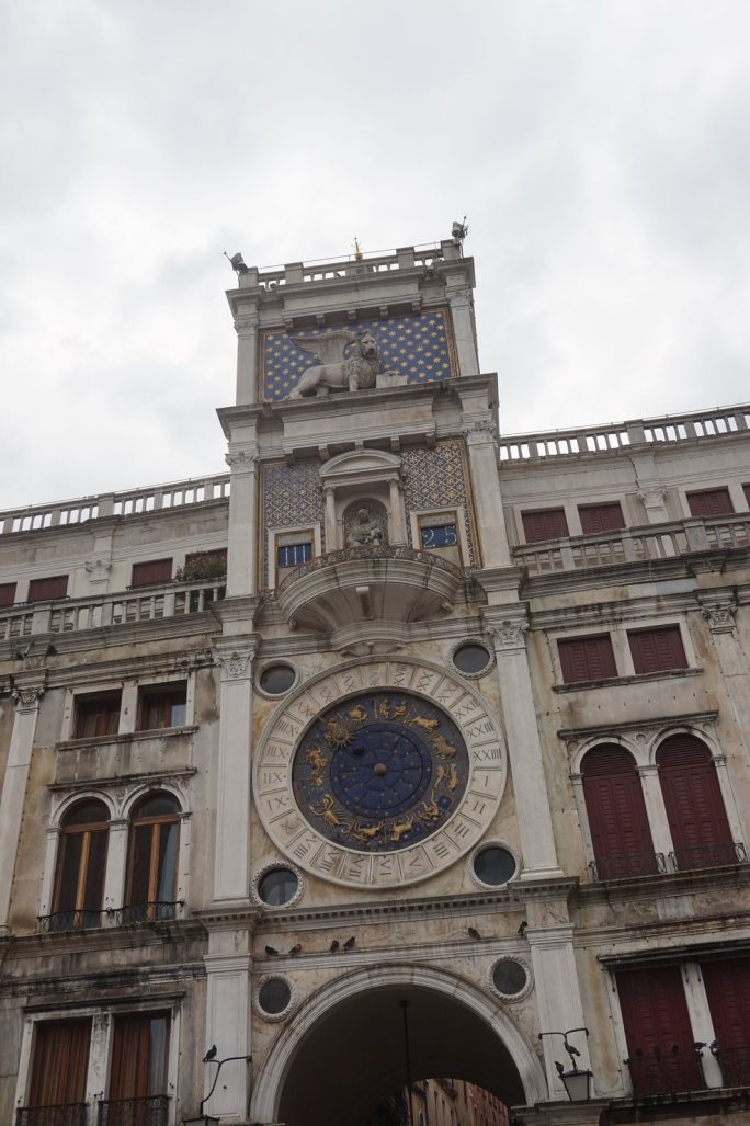 The Torre dell'Orologio in St Mark's Square, the winged lion above the blue and gold astronomical clock