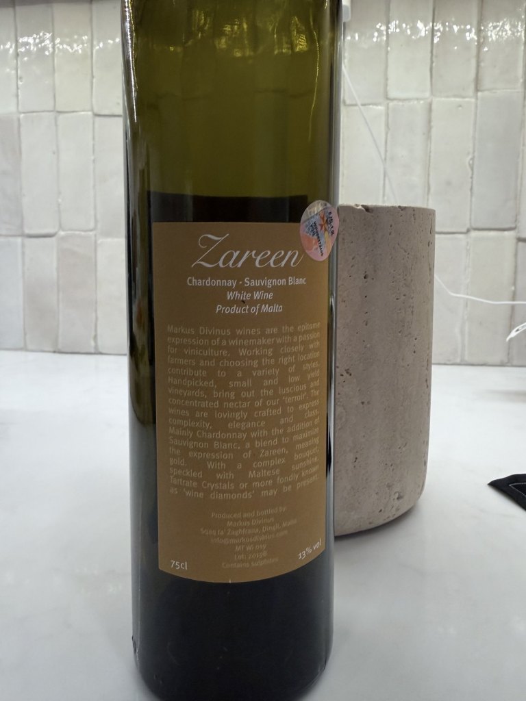 The back label of Zareen 2019, reading Chardonnay Sauvignon Blanc, White Wine, Product of Malta, with the producer text below it